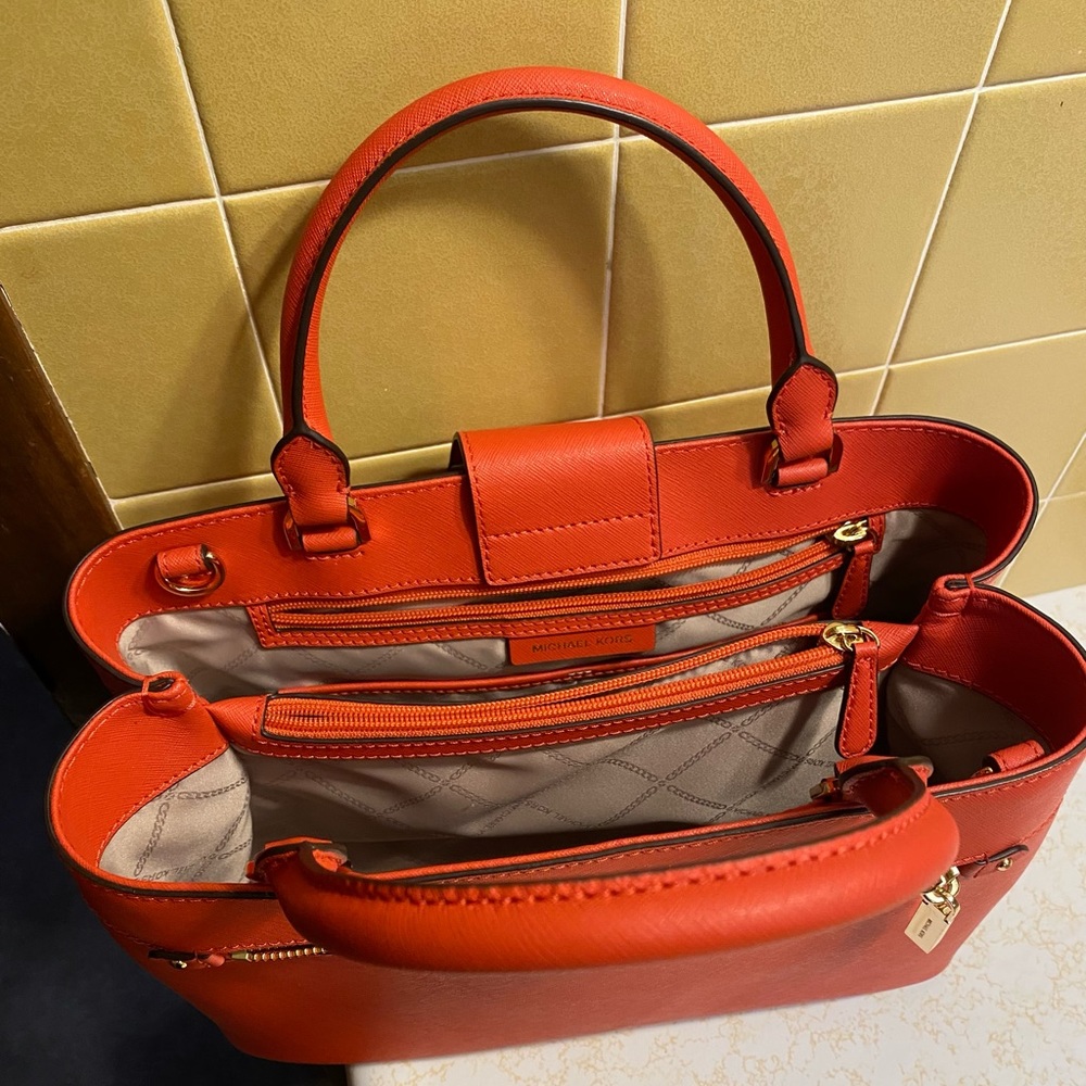 Woman orange Michael Kors handbag worn twice